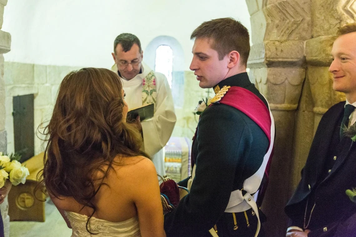 bride and groom exchange marriage vows in St Margaret's Chapel