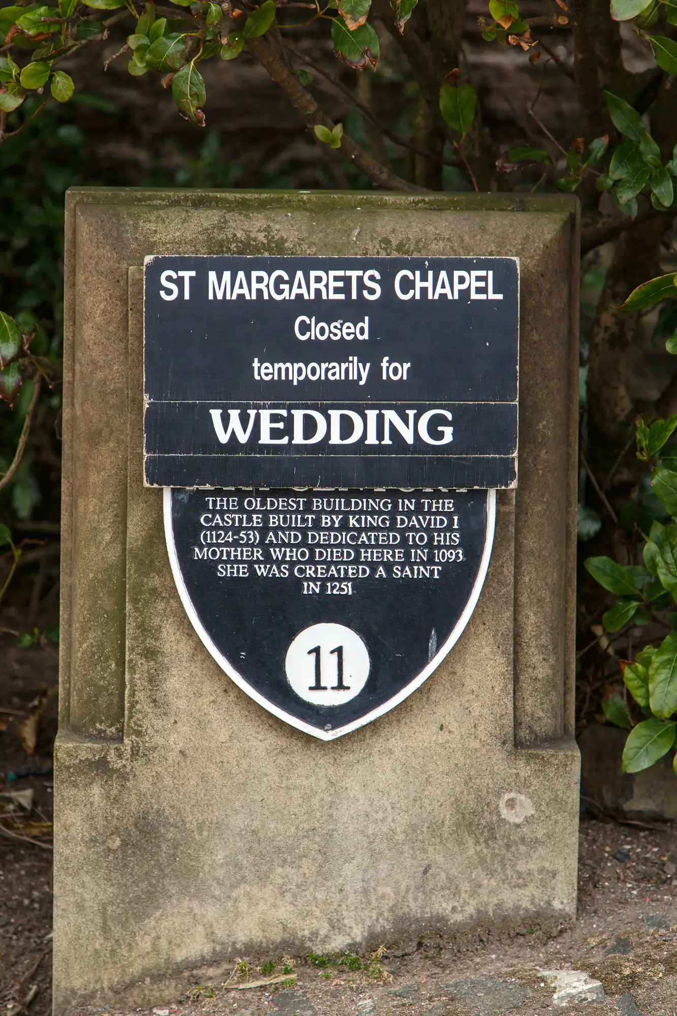 A sign at st margaret's chapel stating it is closed for a wedding, with historical information about the building and its dedication to saint margaret.