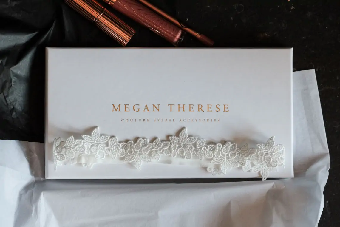 White Megan Therese box with bridal garter sitting on top