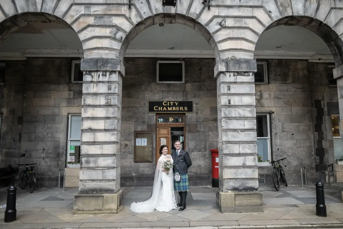 Bride and groom under the entrance archway