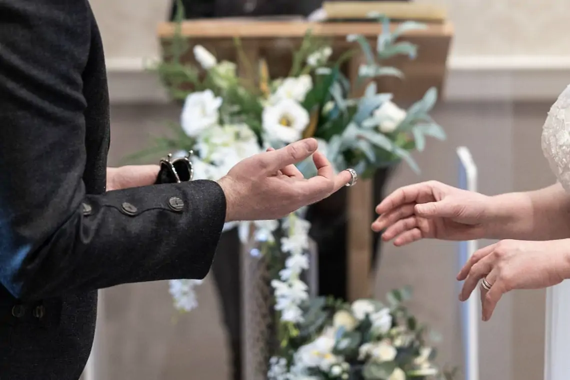 Groom passing ring to bride during ceremony