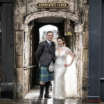Newlyweds standing in the entrance to Advocate's Close in Edinburgh