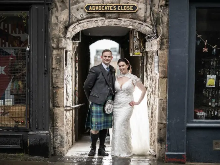 Newlyweds standing in the entrance to Advocate's Close in Edinburgh