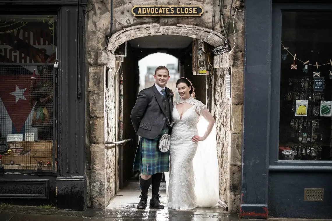 Edinburgh City Chambers wedding ceremony - newlyweds standing in the entrance to Advocate's Close