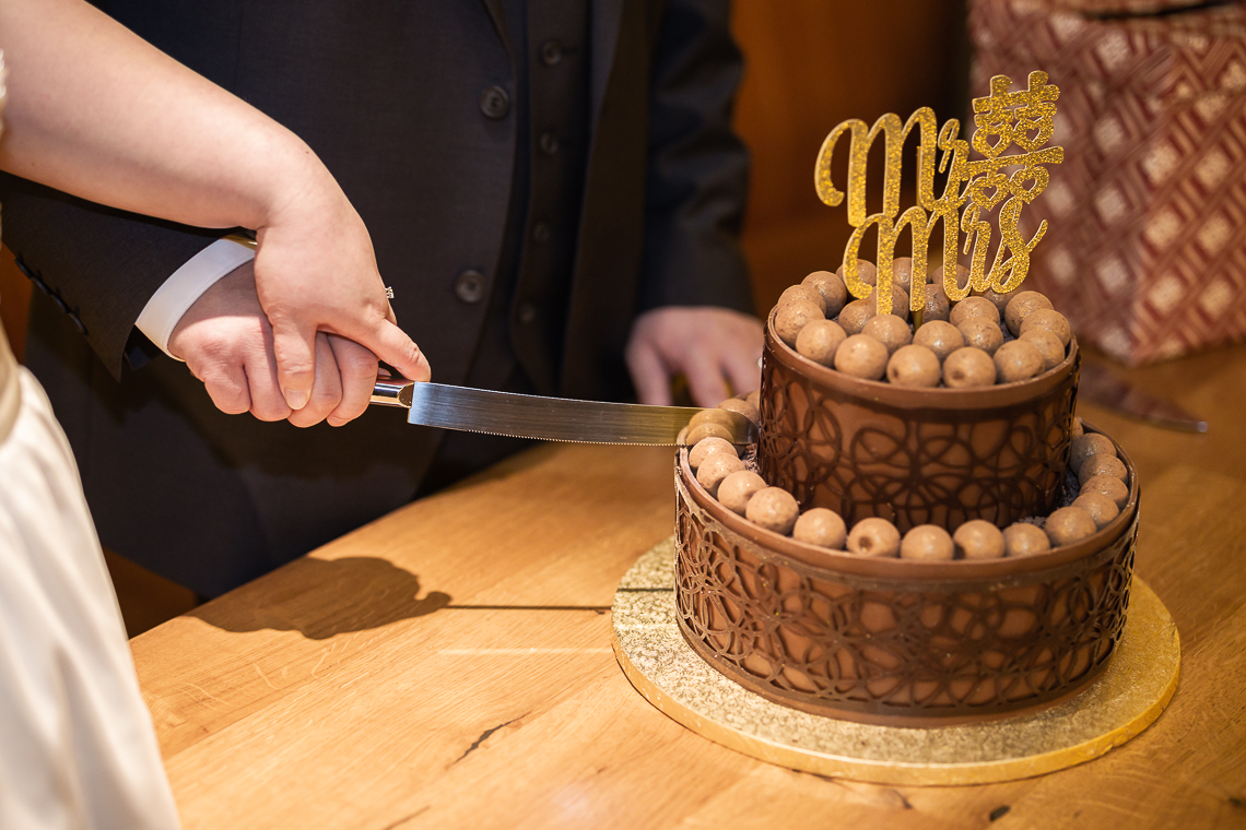 Newlyweds cut their Chocolate wedding cake