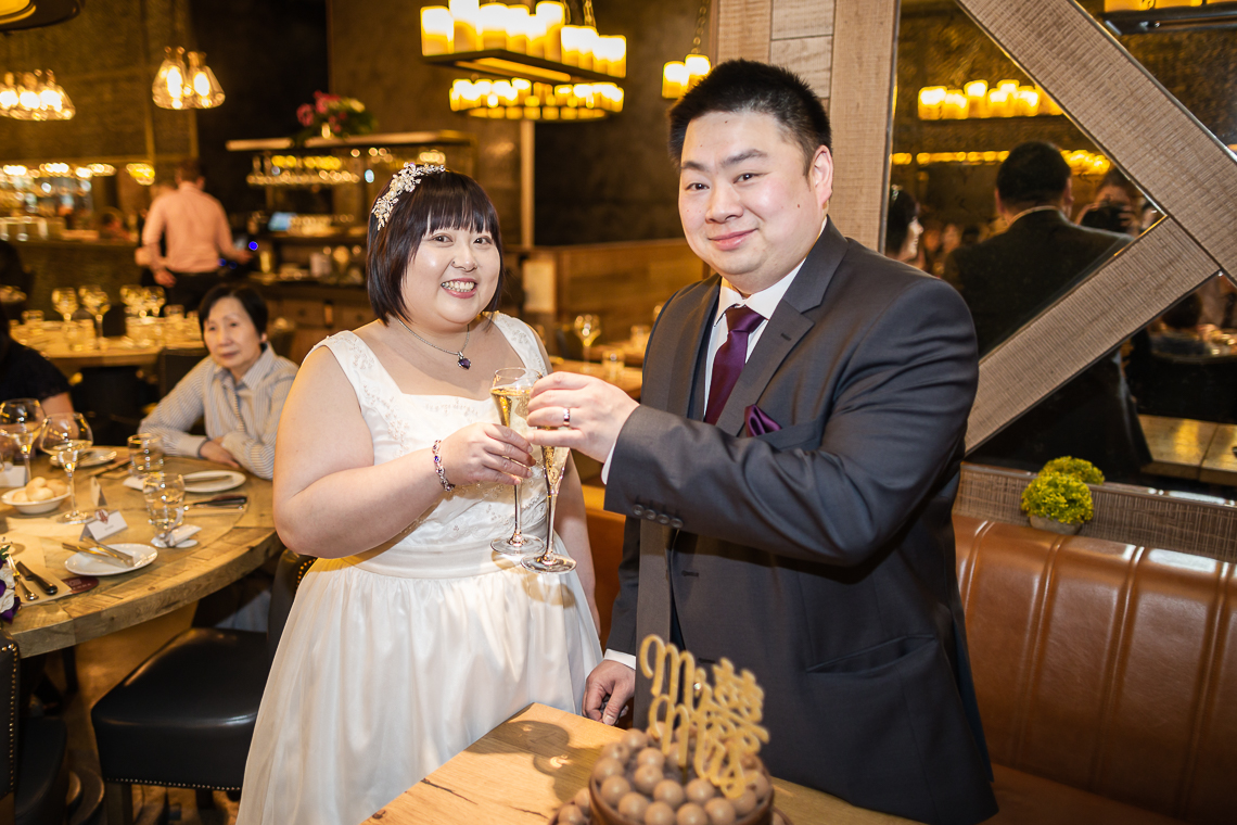Newlyweds toast at their reception at Fazenda restaurant