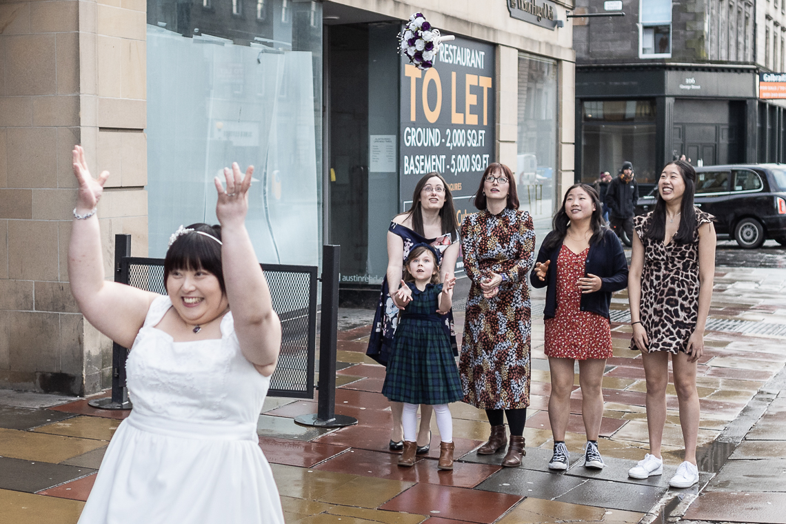 Bride tosses her bouquet on George Street