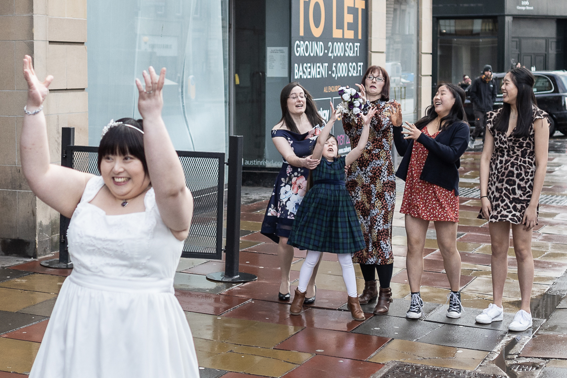 Bride tosses her bouquet on George Street