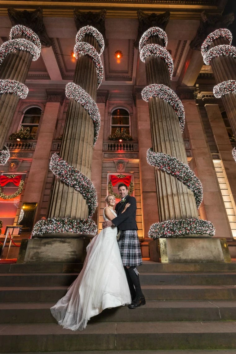 Newly-weds standing outside The Dome in George Street Edinburgh at Christmas