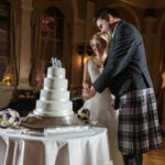 newly-weds cutting wedding cake in the King's Hall