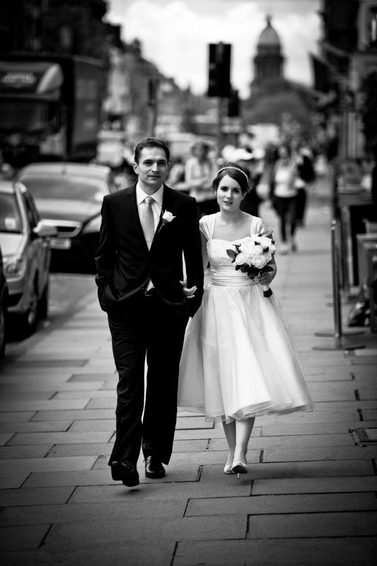 bride and groom walking up Hanover Street