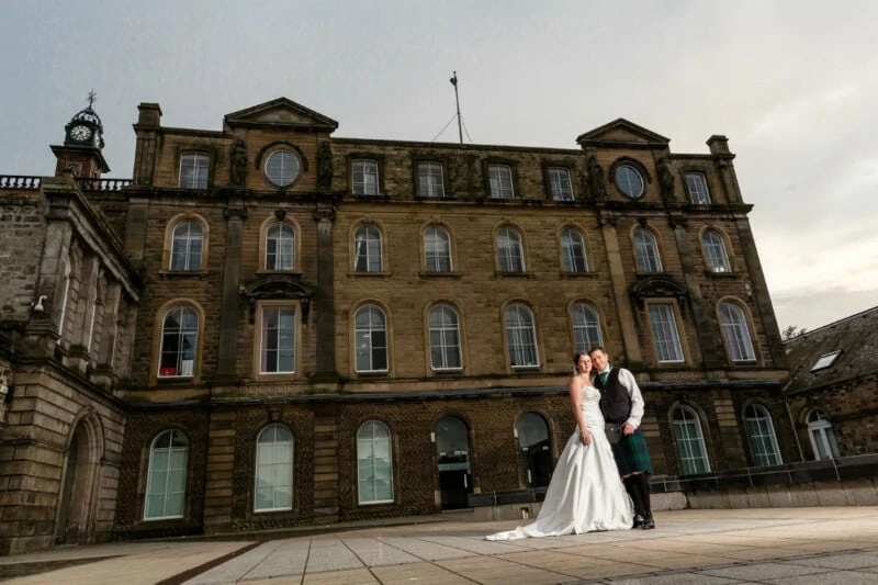 Newlyweds at Eskmills Venue in the courtyard in the evening.