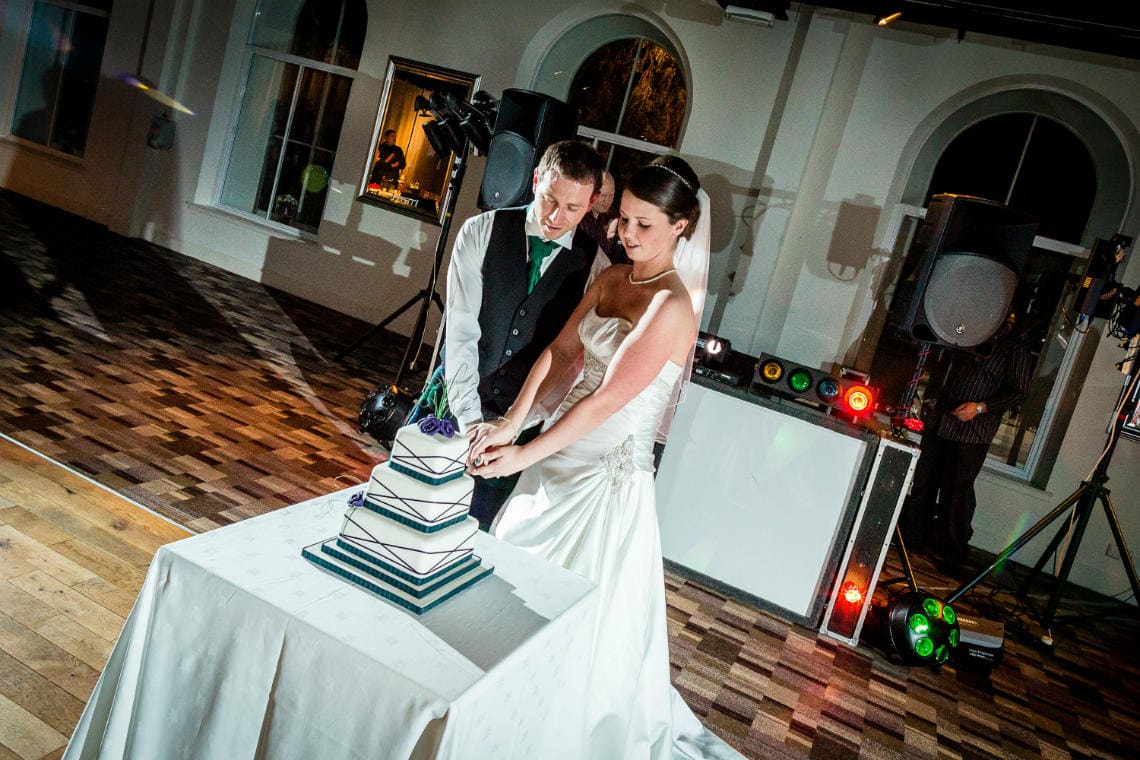 Newlyweds cutting their wedding cake.