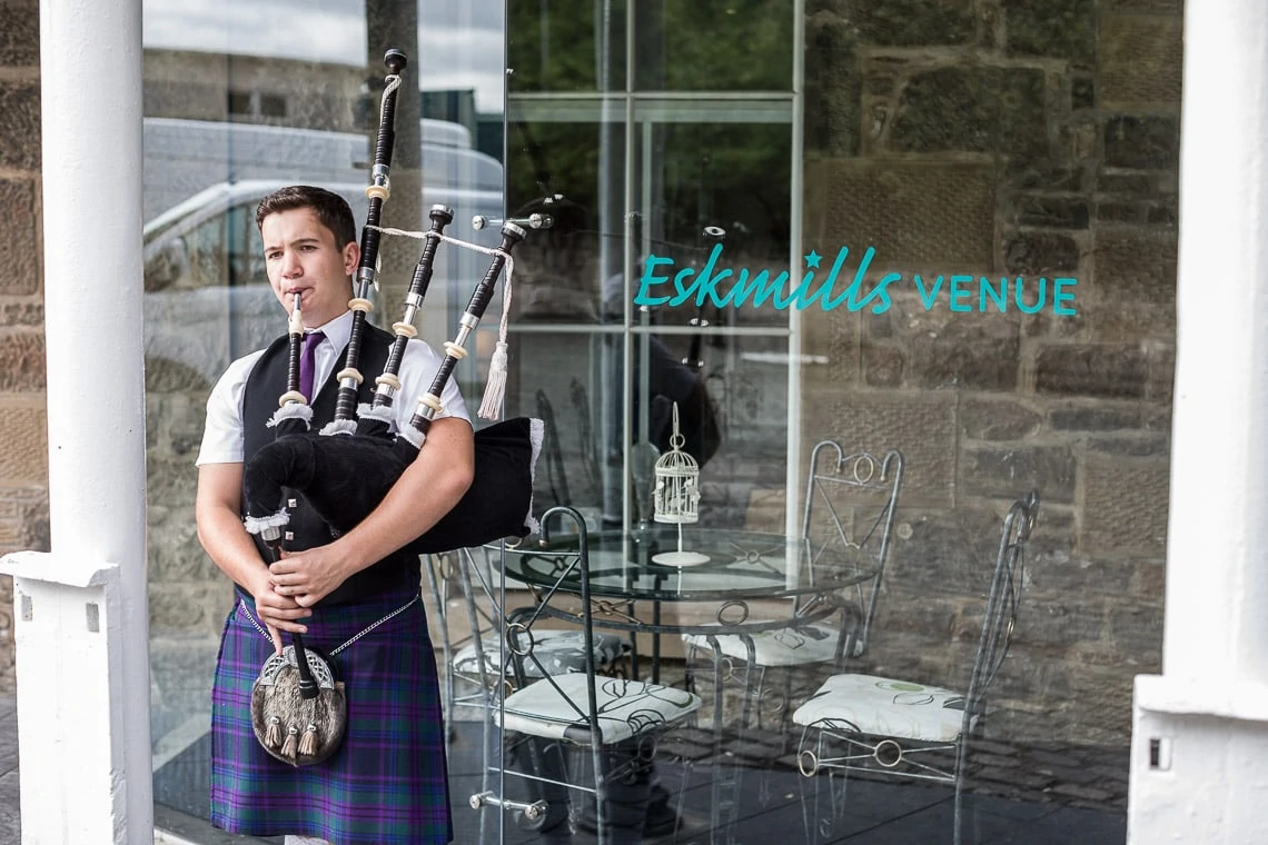 Bagpiper welcomes guests.