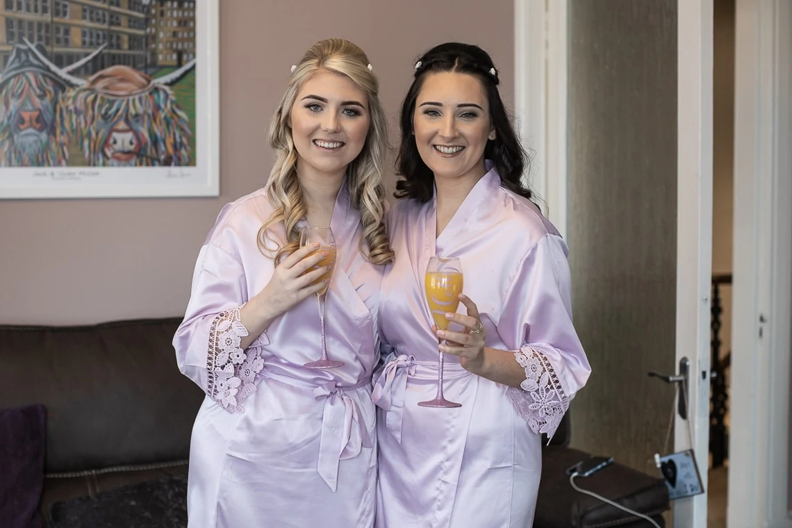 bridesmaids in dressing gowns with a glass of fizz