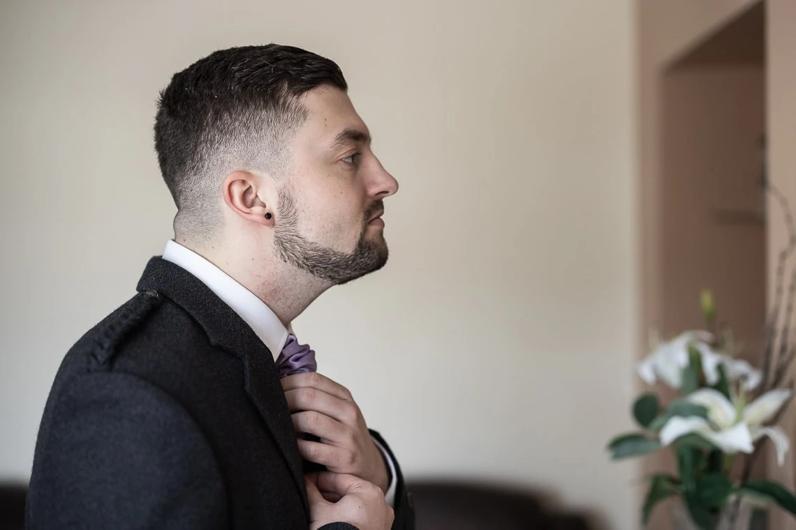 groom adjusting cravat