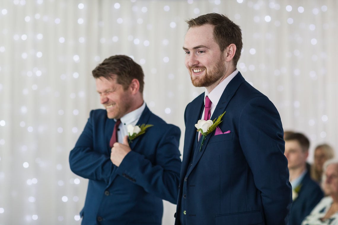 groom smiling at wedding ceremony