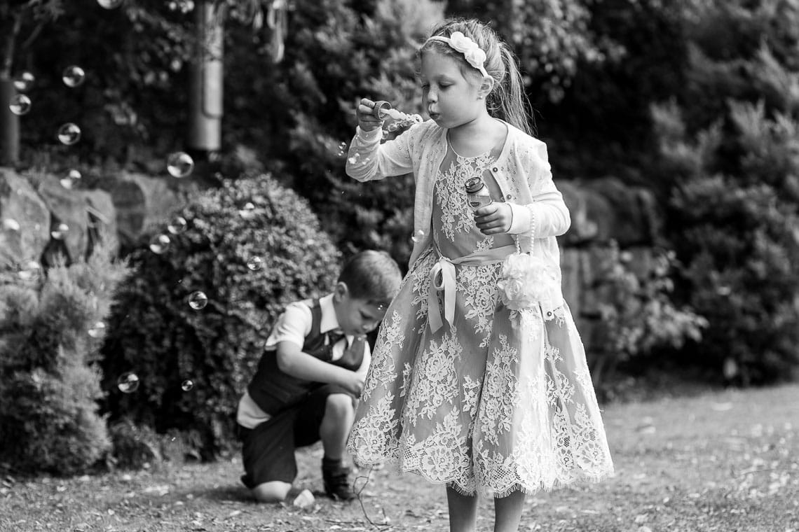 girl blowing bubbles in the garden
