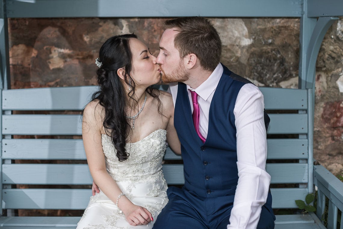 Eskmills Venue Wedding newlyweds kissing on garden bench