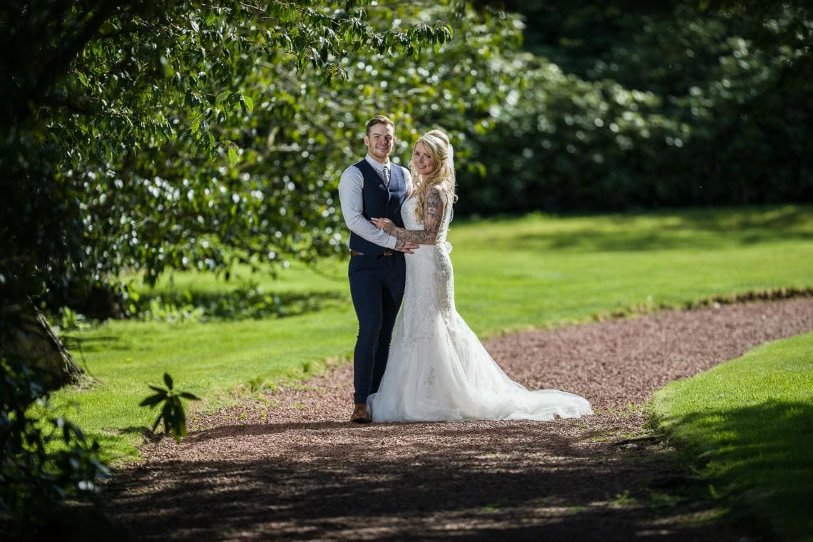Garden - newlyweds embrace on the path