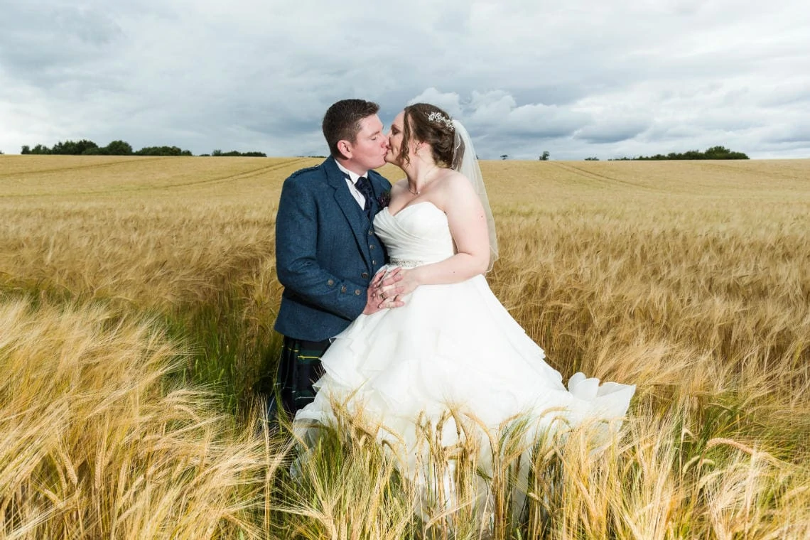 Gardens - newlyweds embrace in the field