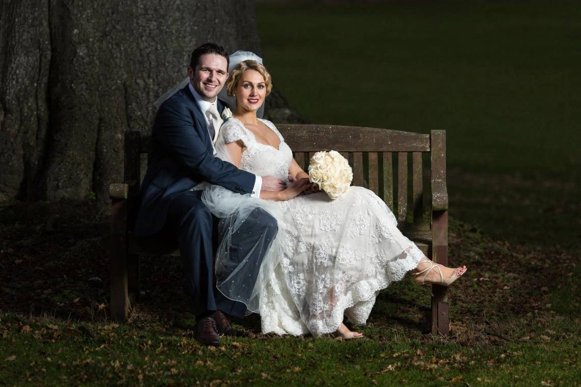 Gardens newlyweds evening photo sitting on a wooden bench