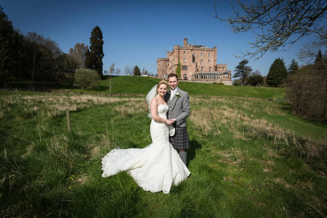 Gardens - newlyweds in the valley with the castle in the background
