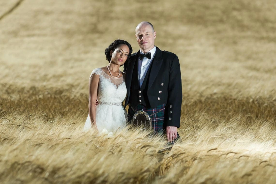 Gardens - newlyweds pose in the field