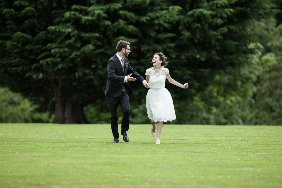 Gardens - newlyweds running across the lawn