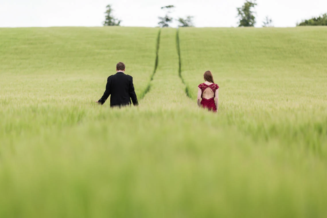 Gardens - newlyweds walking through a field of green