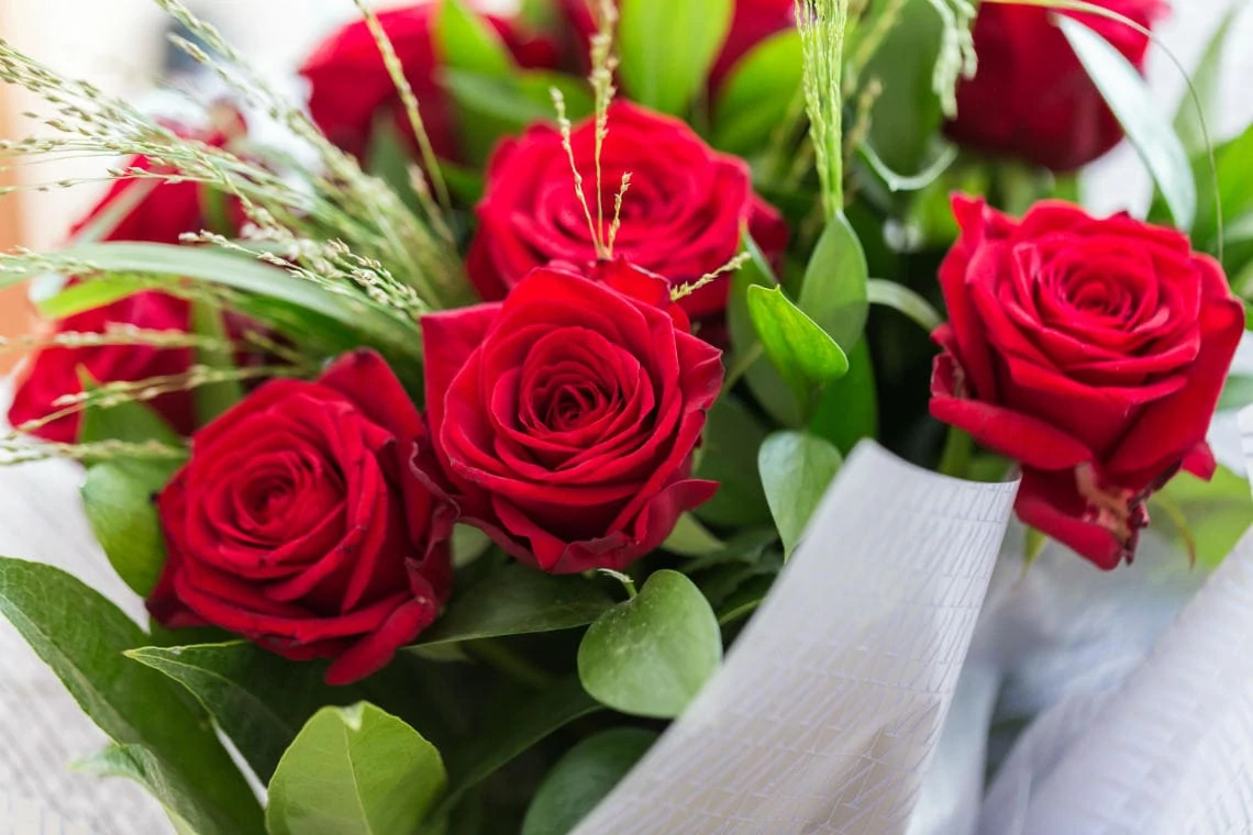 groom's gift of red roses to his bride on their wedding day
