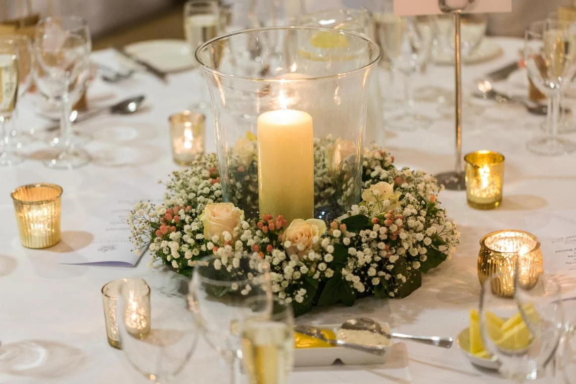 table centre flowers with candle and tealights