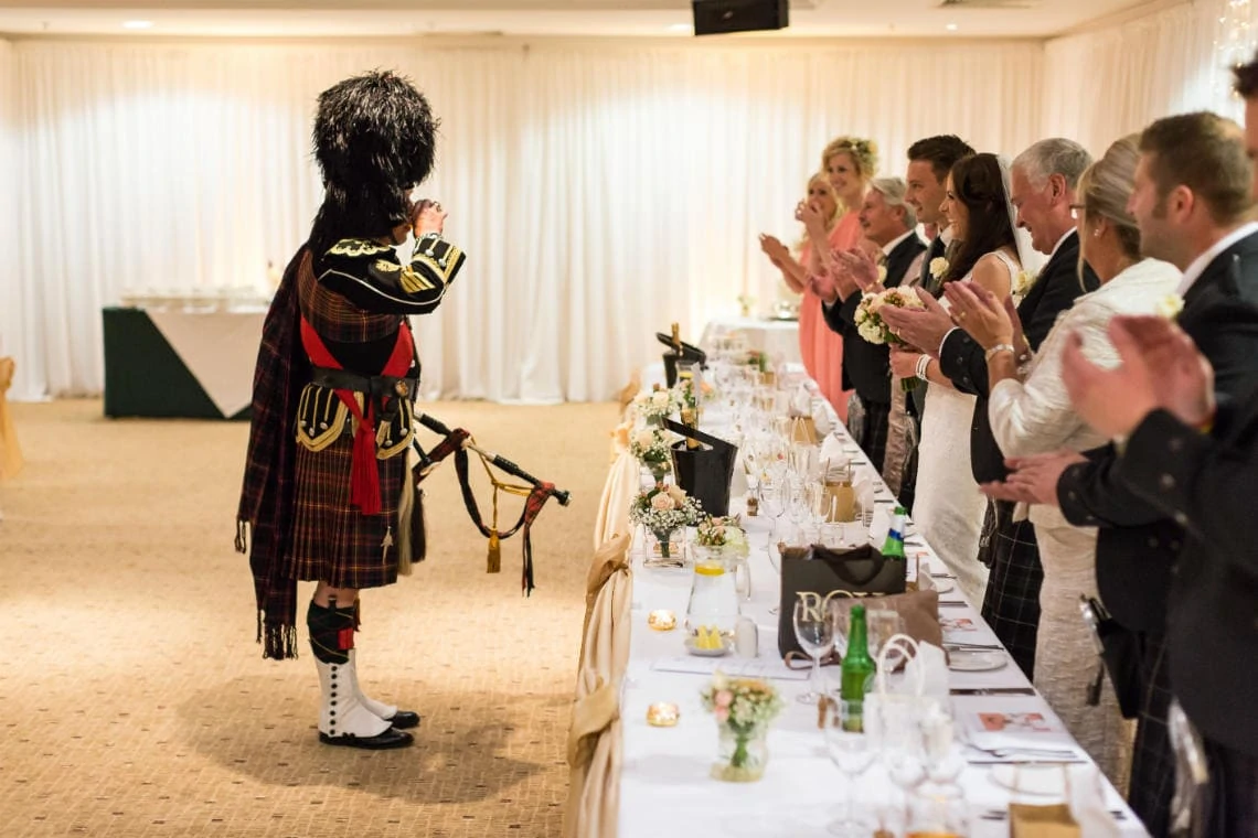 piper enjoys a dram as after toasting the newlyweds in the Dalmahoy Suite
