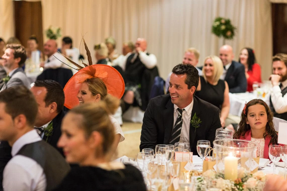 guests laughing during the groom's speech in the Dalmahoy Suite