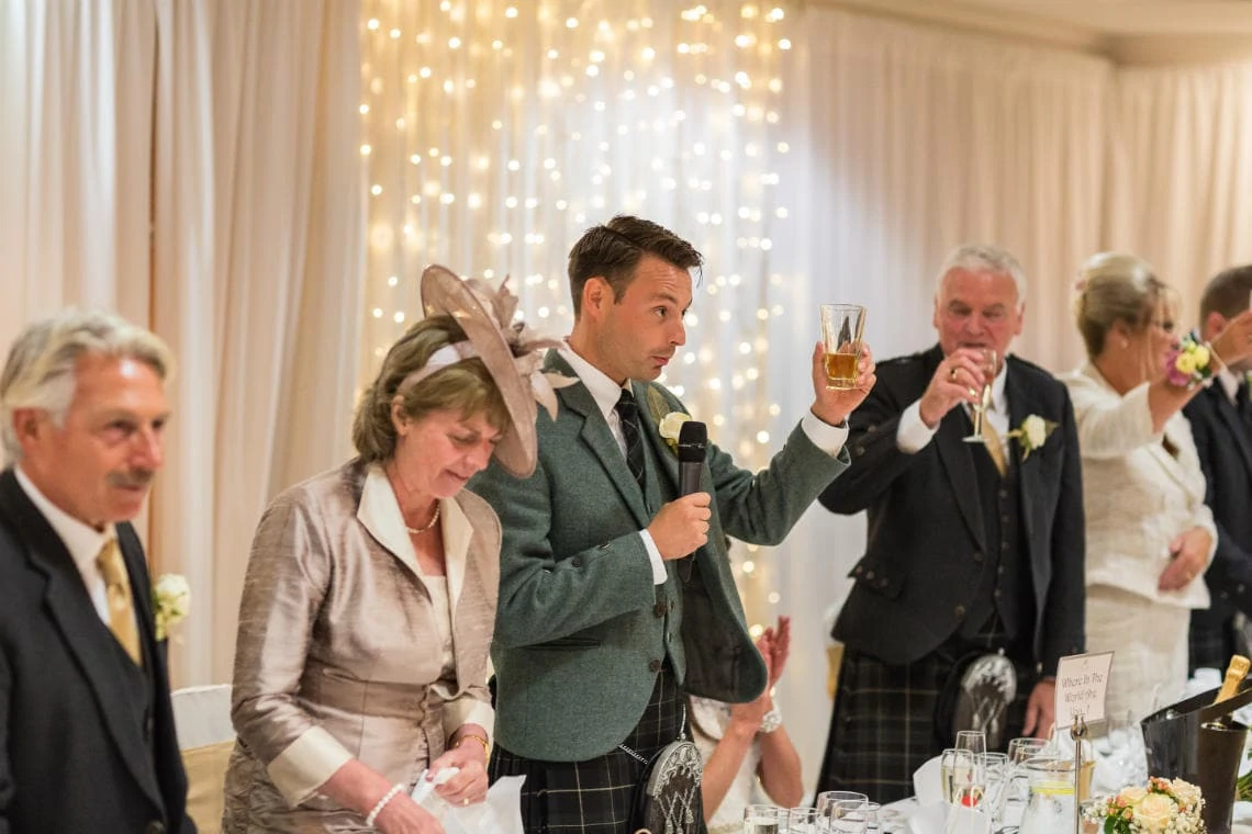 groom raises a toast at the end of his speech in the Dalmahoy Suite