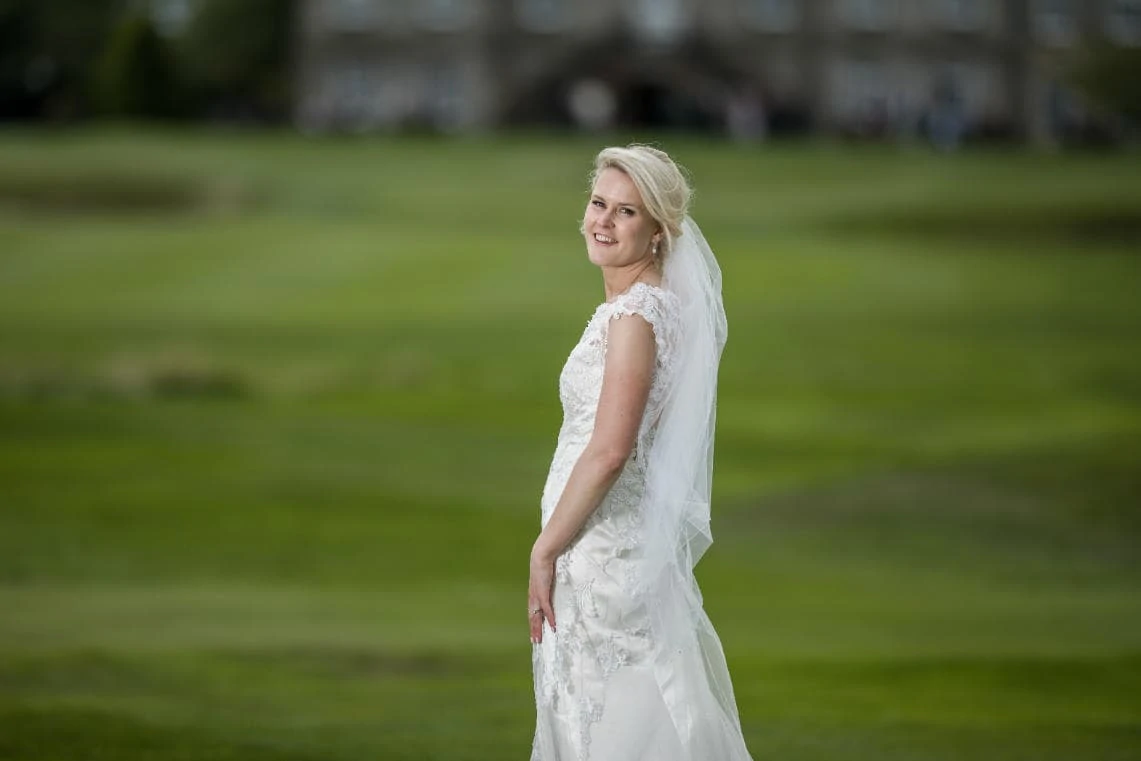 Golf course and grounds - bride looking back towards the camera