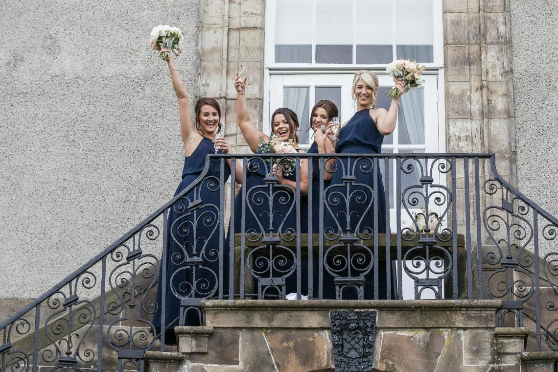 Golf course and grounds - bridesmaids waving on the staircase