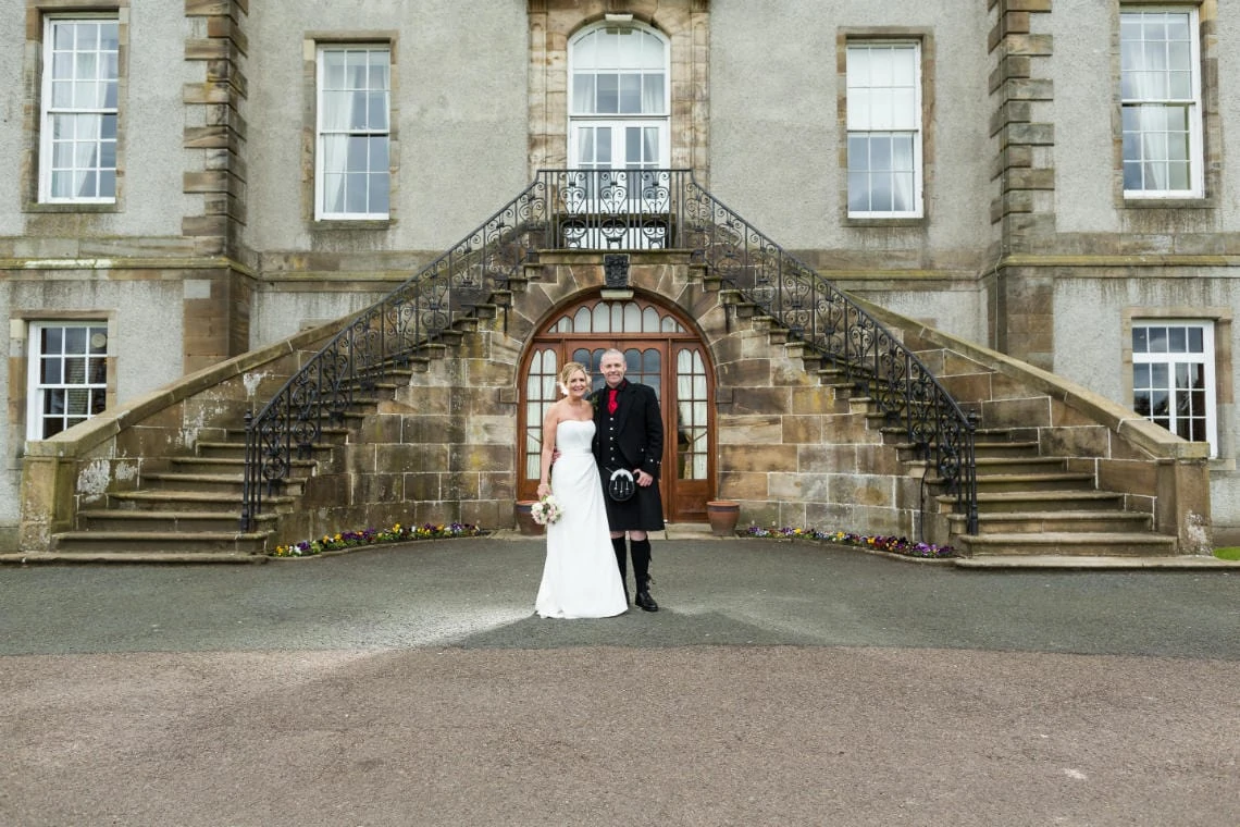 Golf course and grounds - newlyweds in front of the staircase