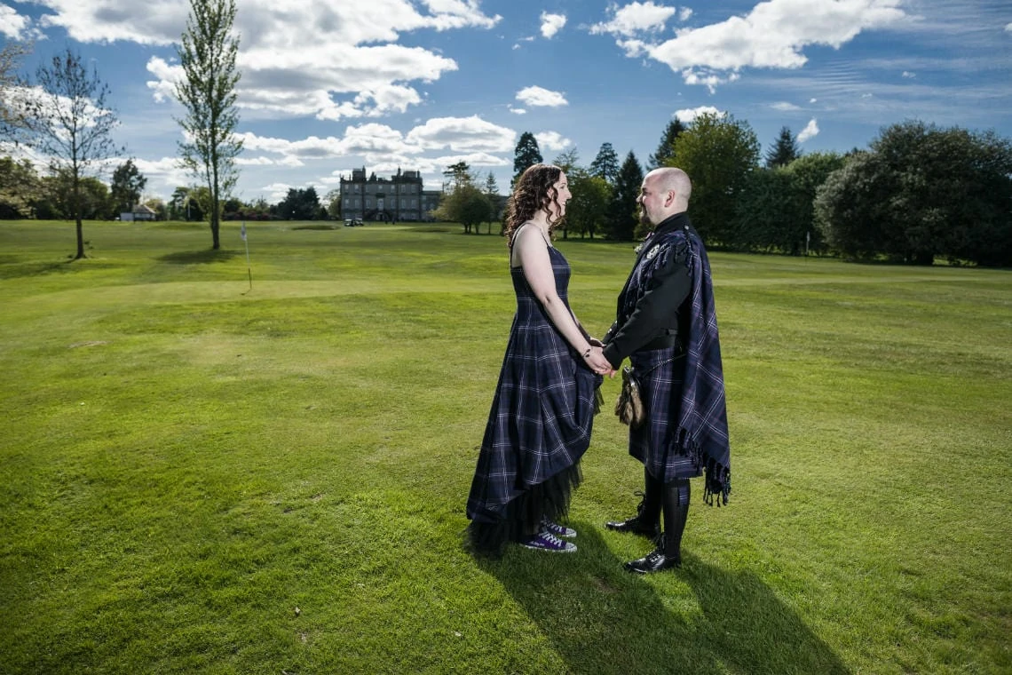 Golf course and grounds - newlyweds looking at each other wide angle