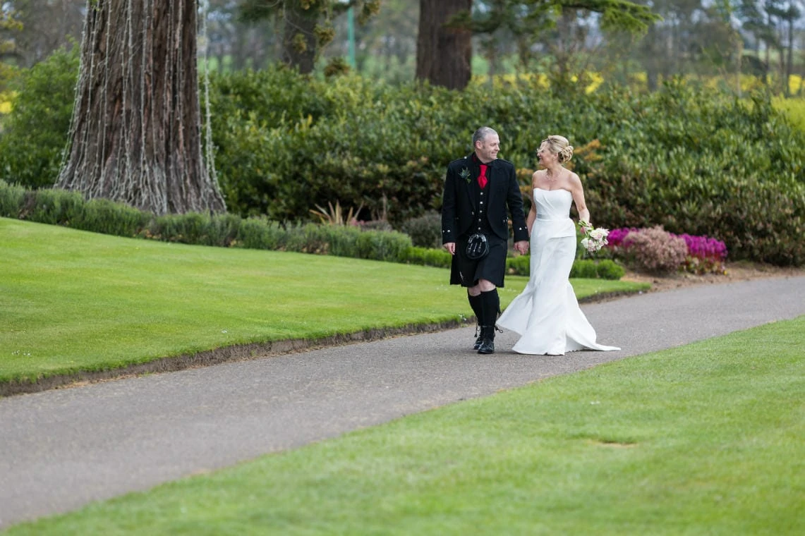 Golf course and grounds - newlyweds strolling along the path