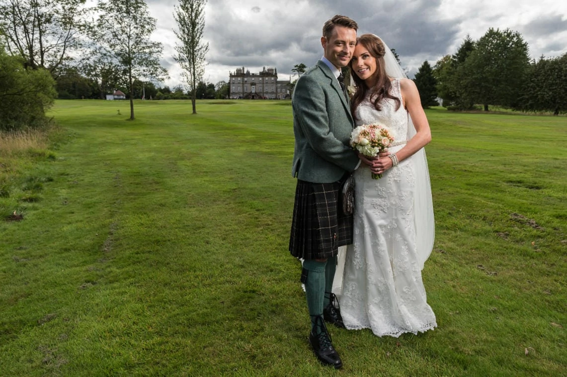 Golf course and grounds - newlyweds wide angle embrace