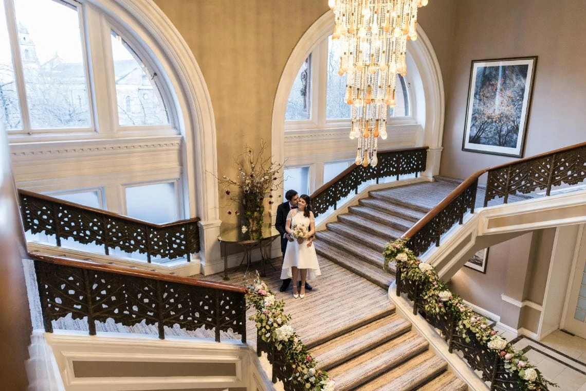 Grand staircase newlyweds embrace