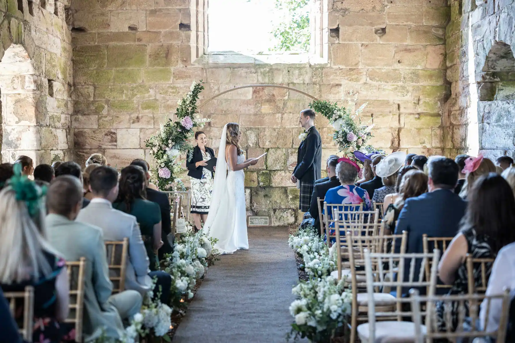 wedding photography photos example - Humanist ceremony beneath the flower arch at Dunglass Estate