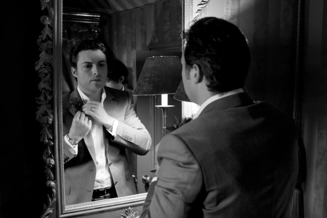 groom looking into mirror
