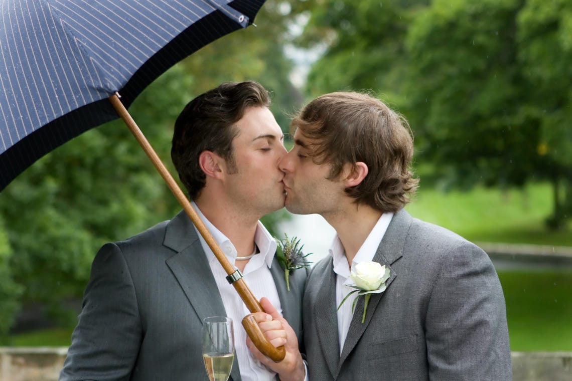 grooms Damian and Clinton on the Tapestry Room Balcony - Prestonfield House wedding photography