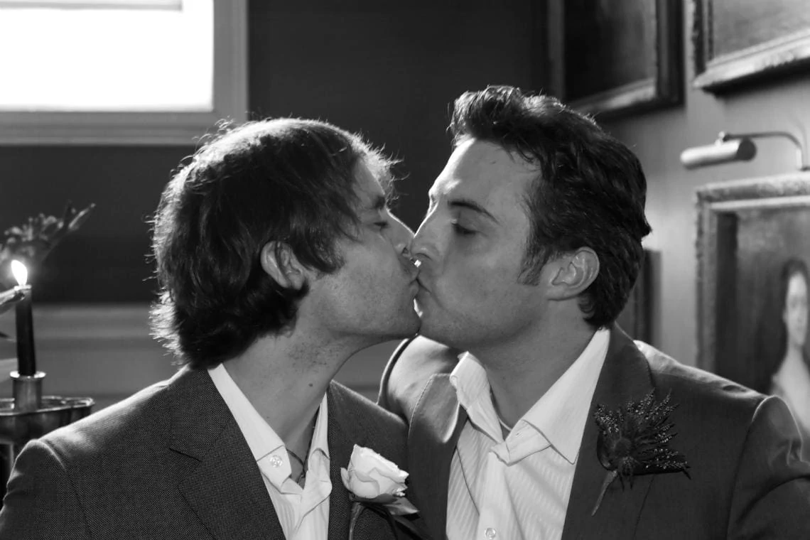 Newlywed gay couple kissing