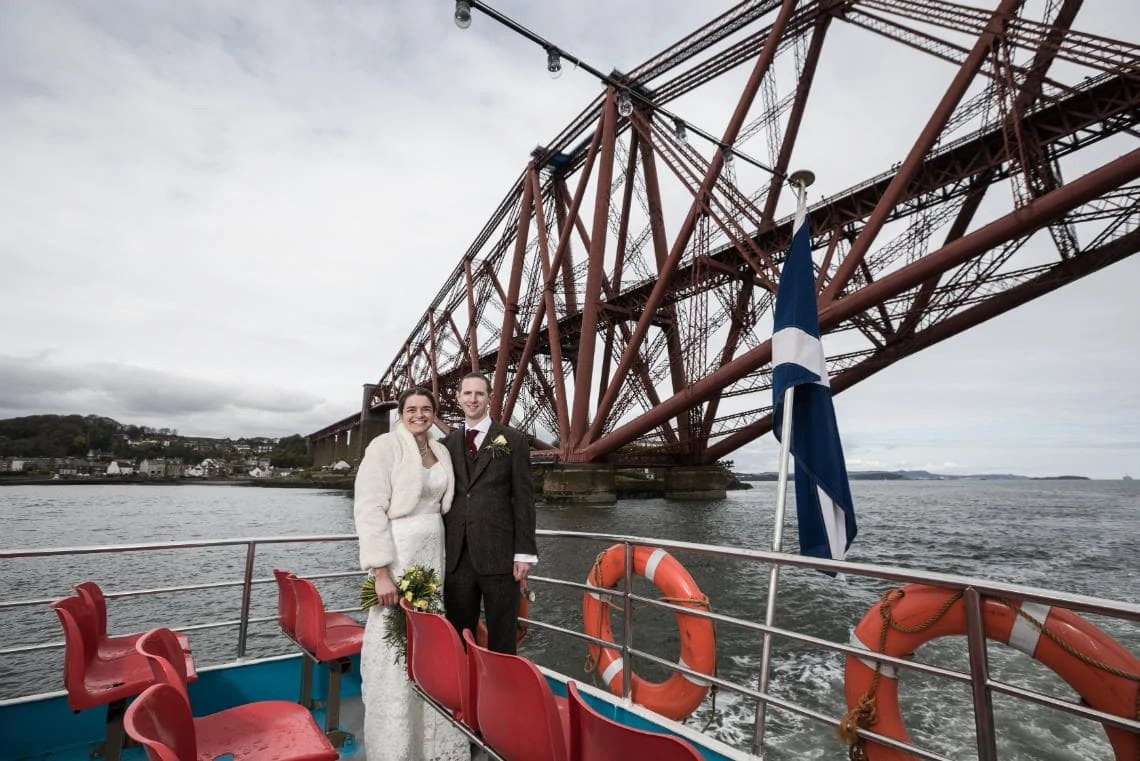 Newlyweds photographed passing the Forth Bridge on The Maid of The Forth