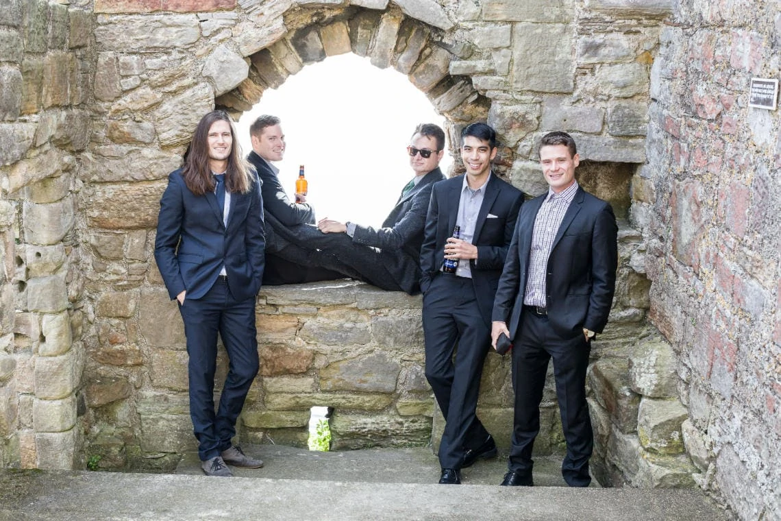 Groom and Groomsmen relaxing having a beer at Inchcolm Abbey