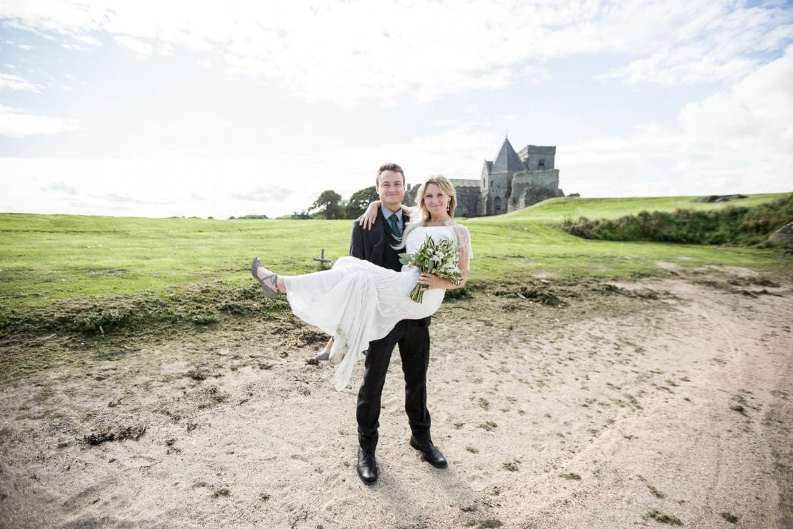 Newly-weds on the beach of Inchcolm Island with Inchcolm Abbey in the background