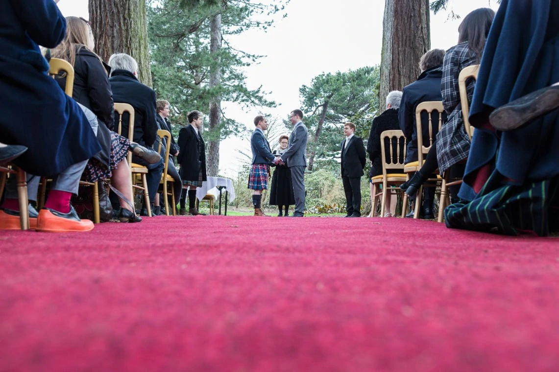 John Muir Grove same sex civil ceremony couple hold hands during exchange of vows